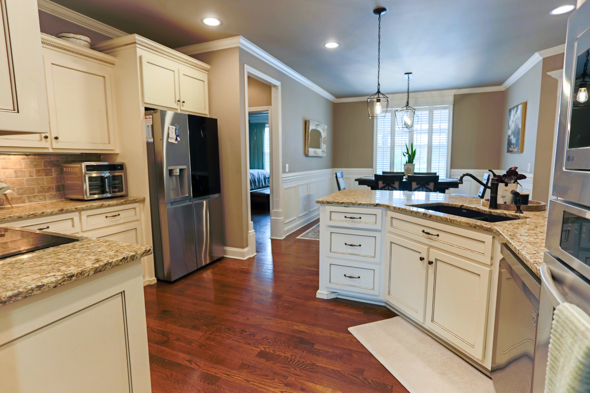 1700 Zevon Court Spring Hill, TN 37174 - Photo 20 of 71 a kitchen with white cabinets and stainless steel appliances