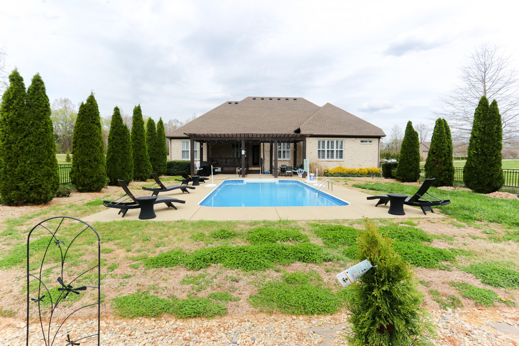 1700 Zevon Court Spring Hill, TN 37174 - Photo 70 of 71 a view of swimming pool with outdoor seating and house in the background
