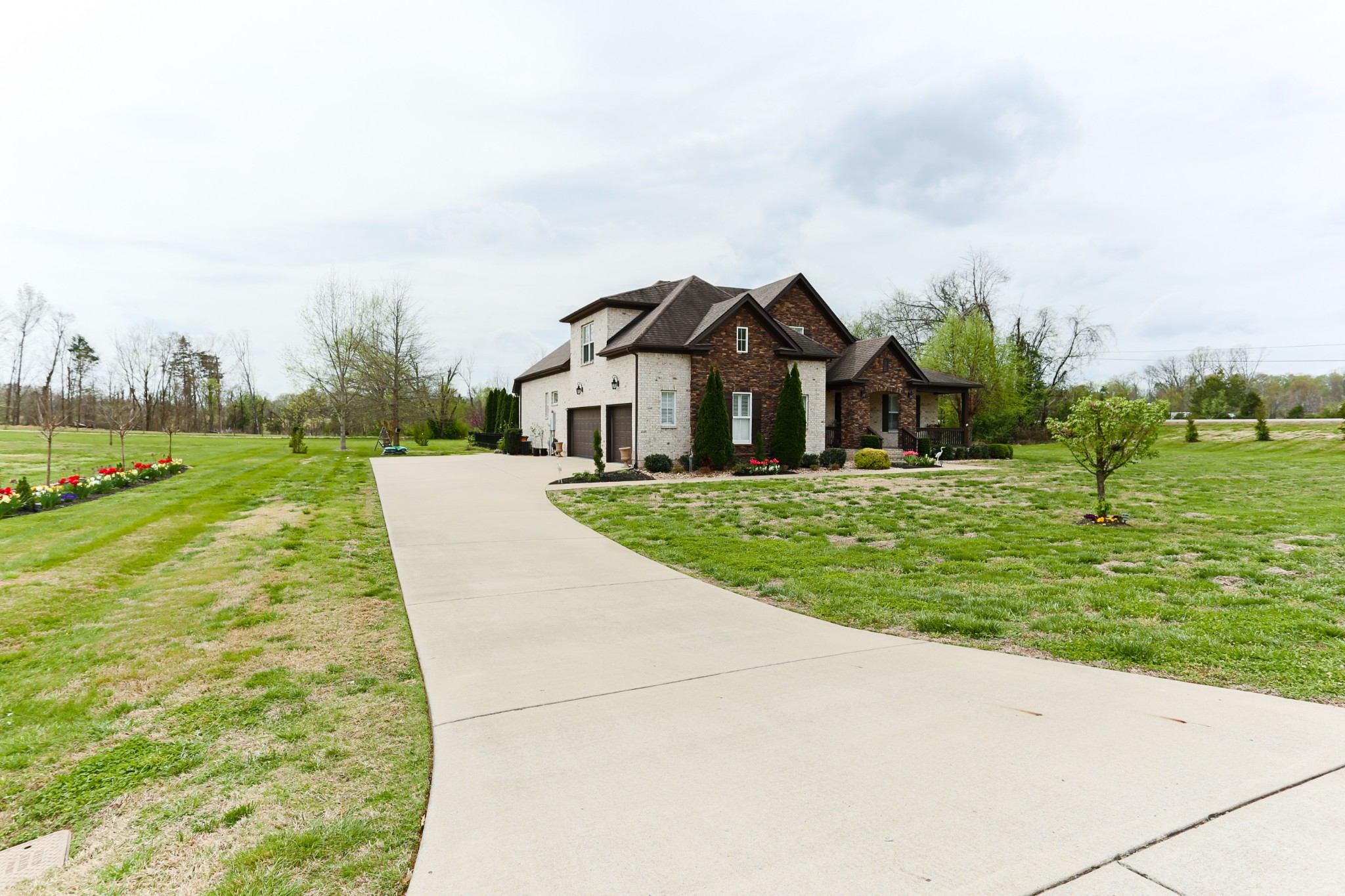 1700 Zevon Court Spring Hill, TN 37174 - Photo 7 of 71 a front view of a house with a yard and trees