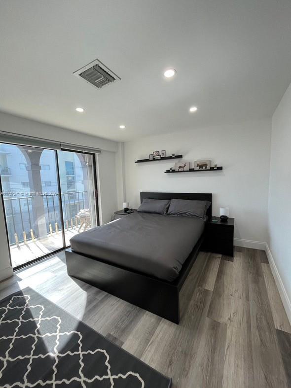777 Southwest 9th Avenue, Unit 406 Miami, FL 33130 - Photo 3 of 11 a bedroom with a bed and large window
