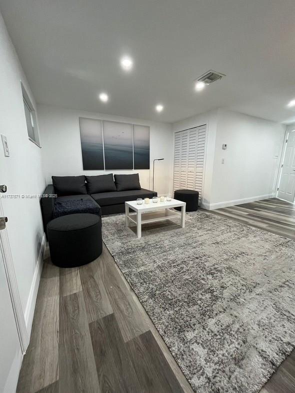 777 Southwest 9th Avenue, Unit 406 Miami, FL 33130 - Photo 6 of 11 a living room with furniture and a wooden floor