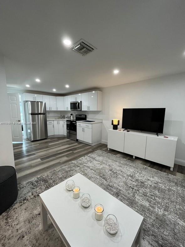 777 Southwest 9th Avenue, Unit 406 Miami, FL 33130 - Photo 7 of 11 a living room with furniture and flat screen tv