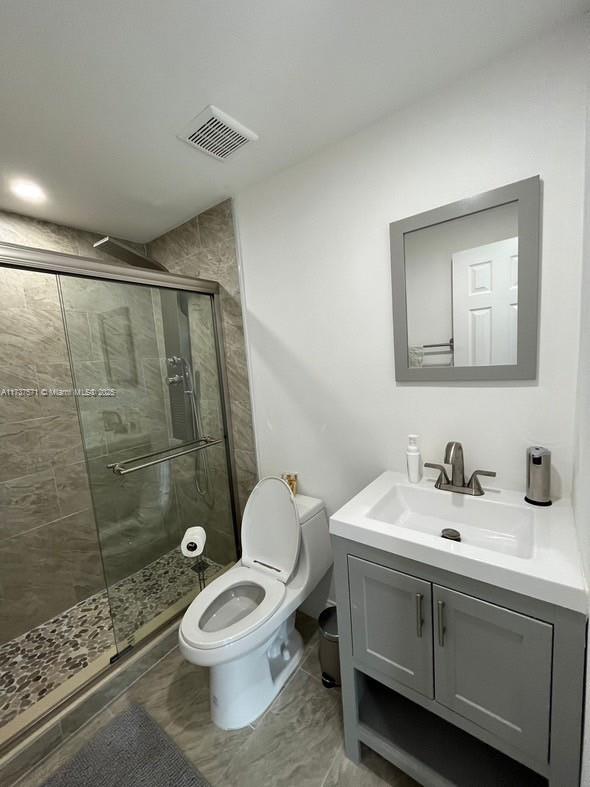 777 Southwest 9th Avenue, Unit 406 Miami, FL 33130 - Photo 8 of 11 a bathroom with a sink a toilet and shower