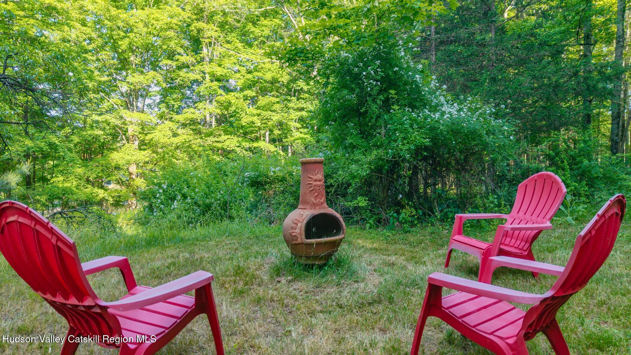 4533 Atwood Road Stone Ridge, NY 12484 - Photo 45 of 63 a backyard of a house with table and chairs