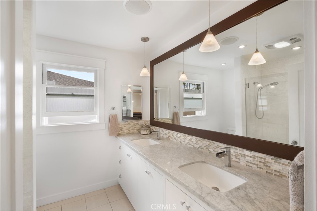 6736 Nicolett Street Riverside, CA 92504 - Photo 21 of 38 a bathroom with a granite countertop sink mirror and double