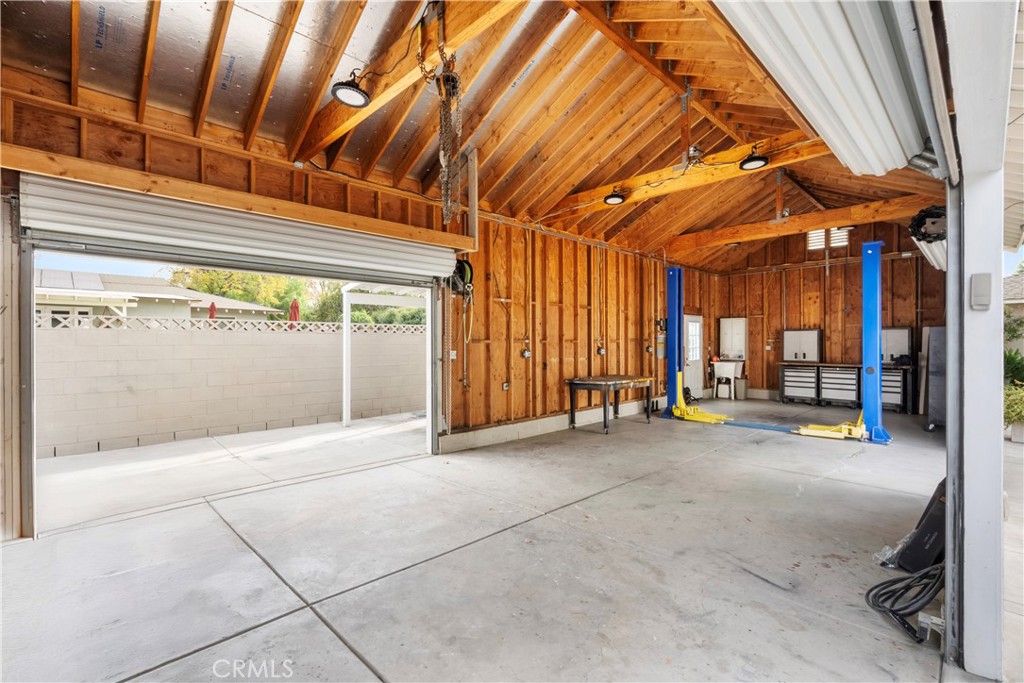 6736 Nicolett Street Riverside, CA 92504 - Photo 32 of 38 a view of an empty room with a fireplace and a chandelier