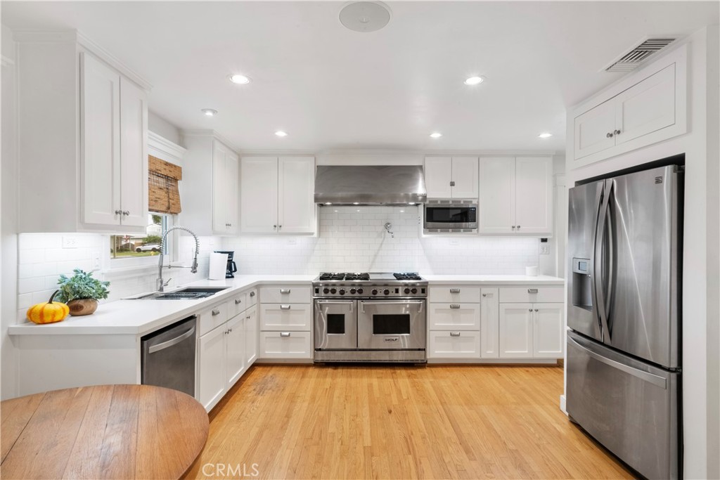 6736 Nicolett Street Riverside, CA 92504 - Photo 6 of 38 a kitchen with stainless steel appliances granite countertop a stove a sink and a refrigerator