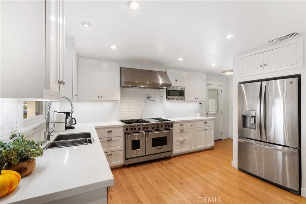 6736 Nicolett Street Riverside, CA 92504 - Photo 8 of 38 a kitchen with a white stove top oven and refrigerator