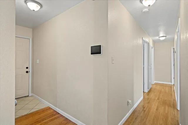a view of a hallway with wooden floor