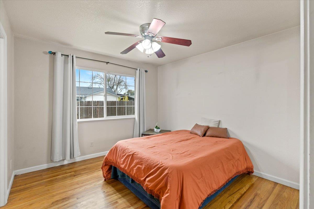 4631 Beechnut Way Sacramento, CA 95823 - Photo 13 of 32 a bedroom with a bed and wooden floor