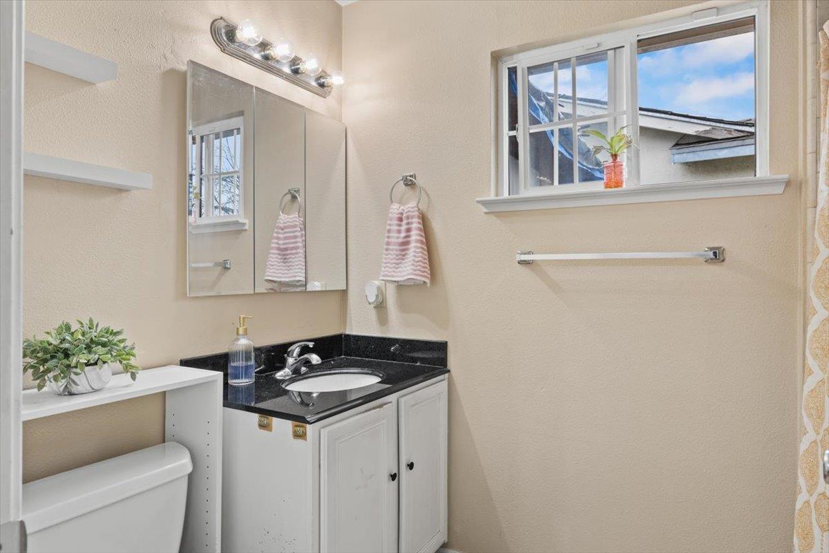 4631 Beechnut Way Sacramento, CA 95823 - Photo 16 of 32 a sink and a mirror in a bathroom