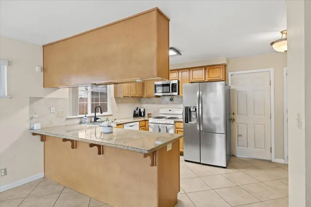 a kitchen with refrigerator and countertop
