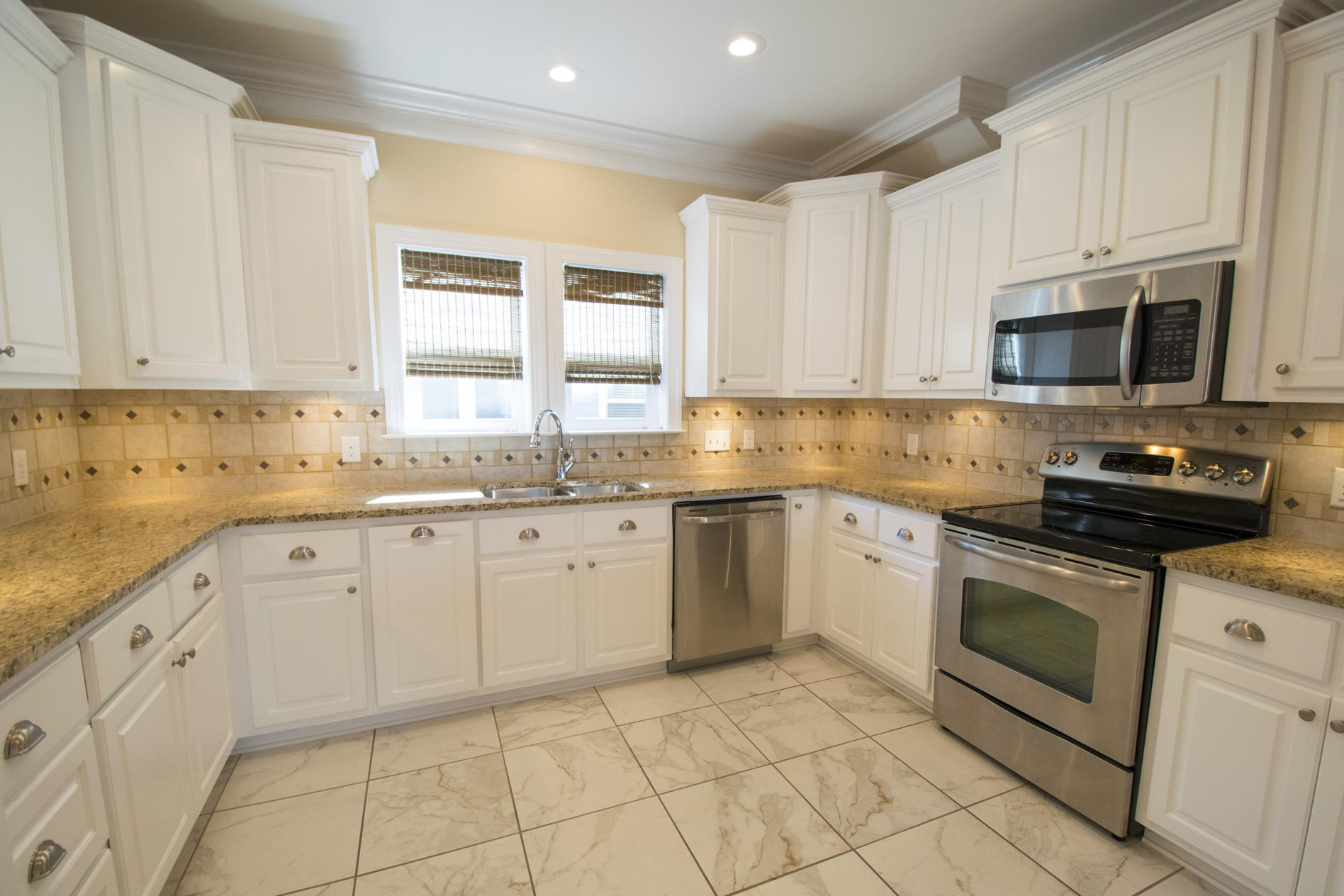 35 The Greenway Loop Inlet Beach, FL 32461 - Photo 13 of 37 a kitchen with granite countertop white cabinets sink and stainless steel appliances