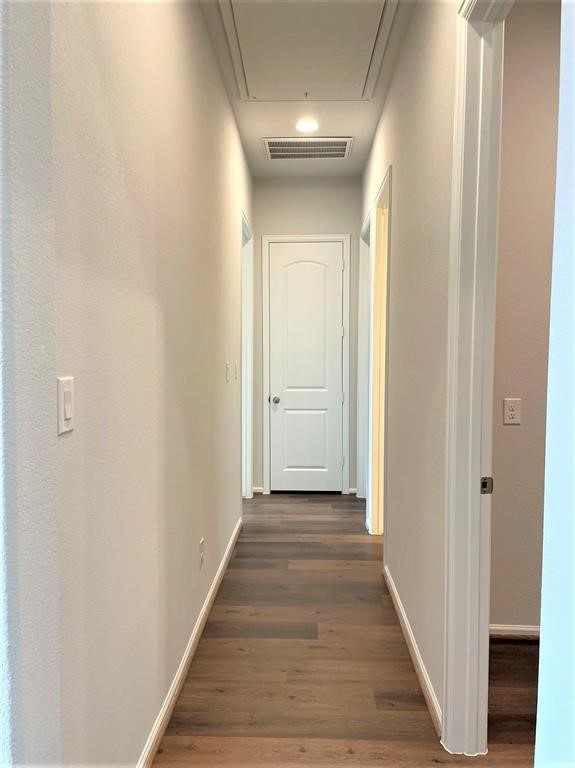 156 Santa Maria Street Georgetown, TX 78628 - Photo 18 of 40 Hallway with dark wood-style floors and baseboards