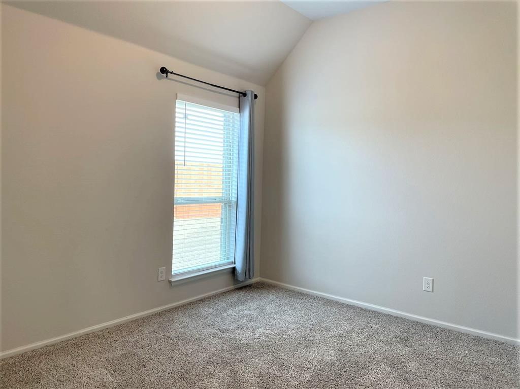 156 Santa Maria Street Georgetown, TX 78628 - Photo 20 of 40 Carpeted empty room featuring baseboards and lofted ceiling