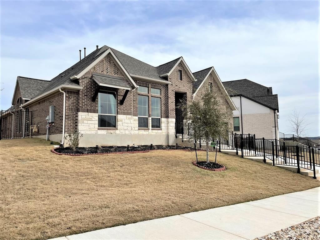 156 Santa Maria Street Georgetown, TX 78628 - Photo 2 of 40 View of front of property featuring brick siding, roof with shingles, and stone siding