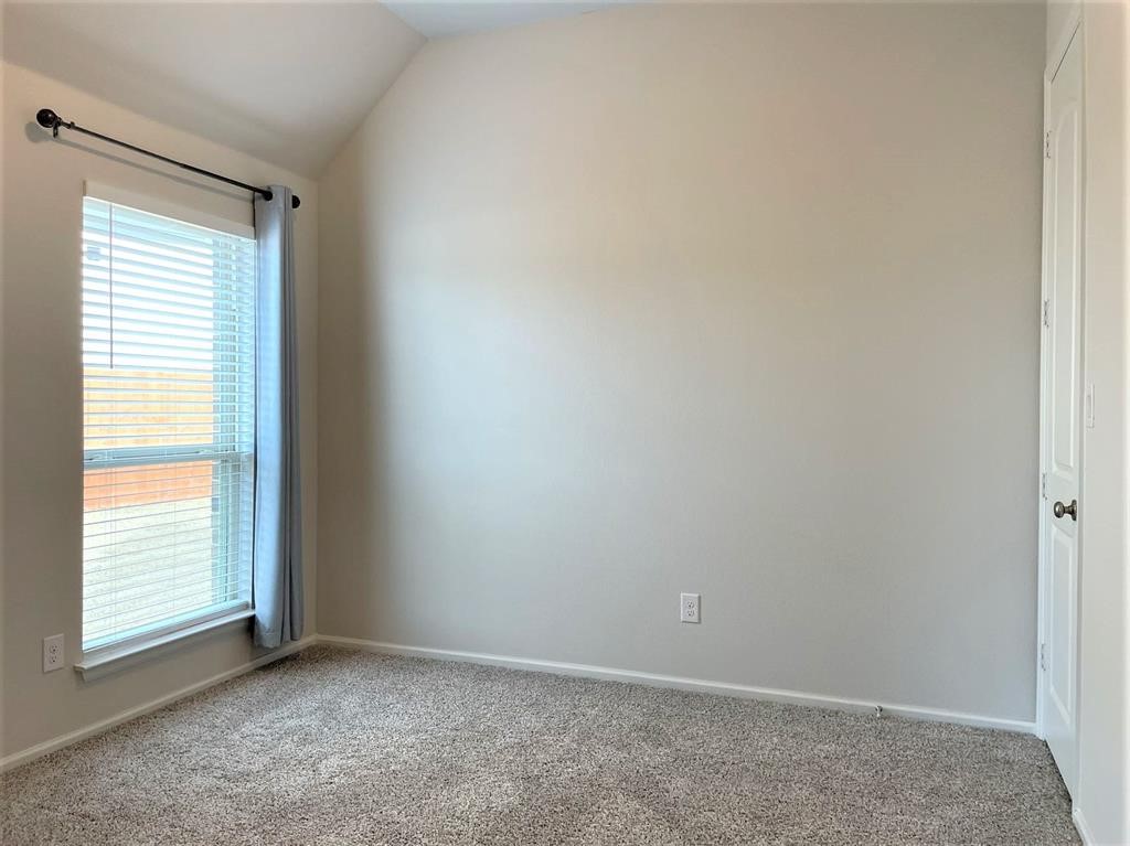 156 Santa Maria Street Georgetown, TX 78628 - Photo 21 of 40 Carpeted empty room featuring baseboards and lofted ceiling