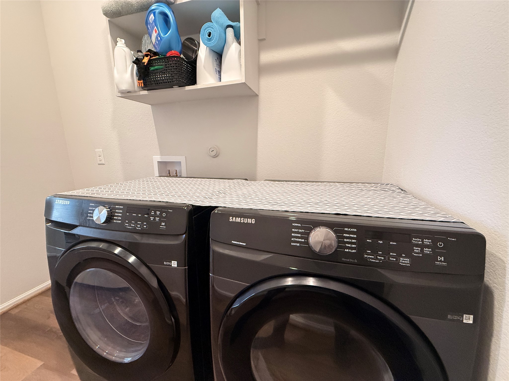 156 Santa Maria Street Georgetown, TX 78628 - Photo 23 of 40 Laundry room featuring washer and dryer and a textured wall