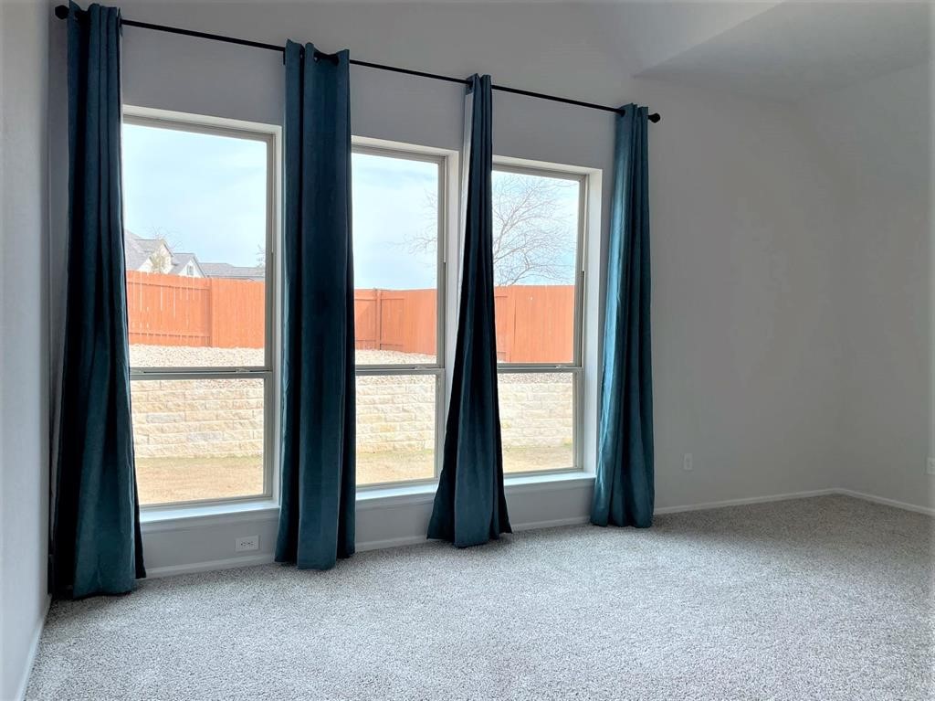 156 Santa Maria Street Georgetown, TX 78628 - Photo 25 of 40 Spare room with light colored carpet and baseboards