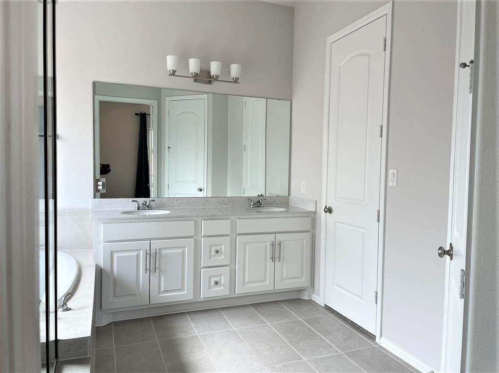 156 Santa Maria Street Georgetown, TX 78628 - Photo 27 of 40 Bathroom featuring double vanity and light tile patterned floors