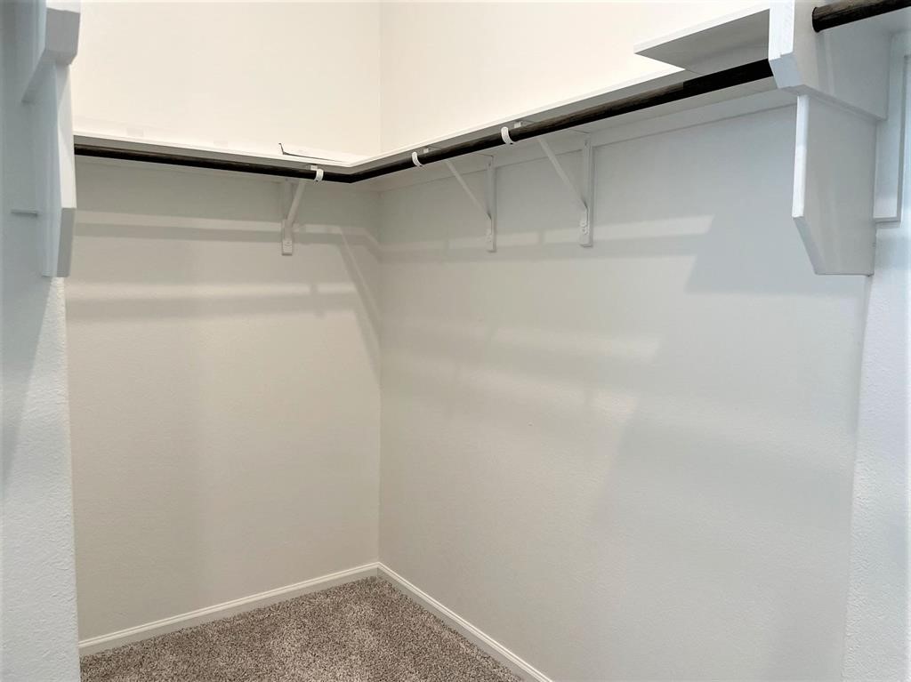 156 Santa Maria Street Georgetown, TX 78628 - Photo 29 of 40 Walk in closet featuring dark carpet