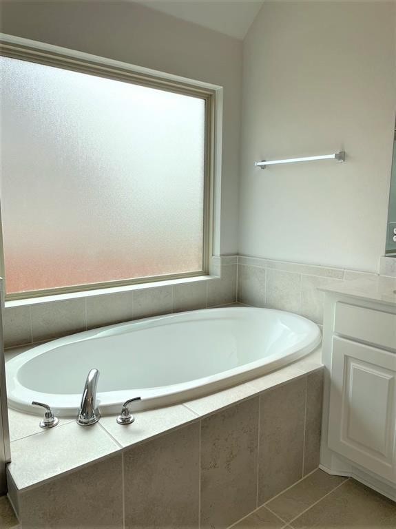 156 Santa Maria Street Georgetown, TX 78628 - Photo 31 of 40 Full bath with vanity, a garden tub, and light tile patterned floors