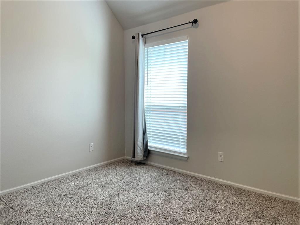 156 Santa Maria Street Georgetown, TX 78628 - Photo 32 of 40 Spare room featuring light carpet and lofted ceiling