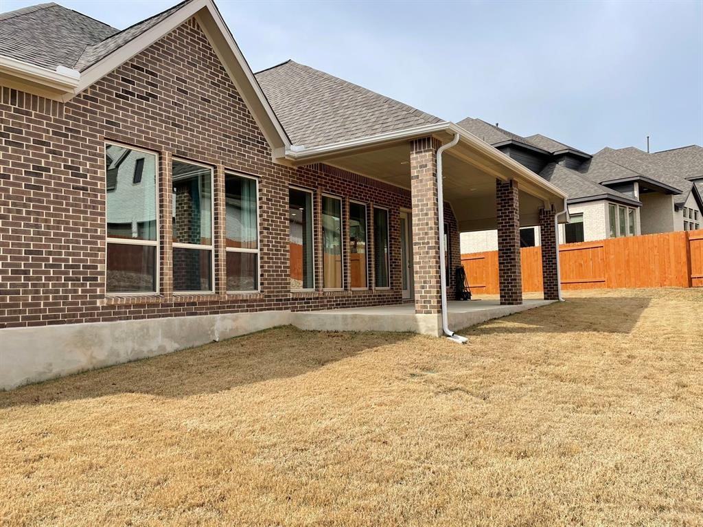 156 Santa Maria Street Georgetown, TX 78628 - Photo 35 of 40 Rear view of house with a patio area, brick siding, and a shingled roof