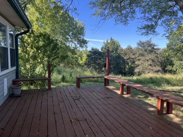 a view of deck with wooden floor and seating space