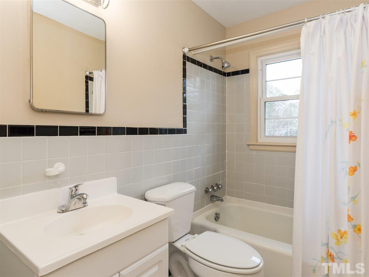 4321 James Road Raleigh, NC 27616 - Photo 17 of 23 a bathroom with a sink toilet a mirror and shower