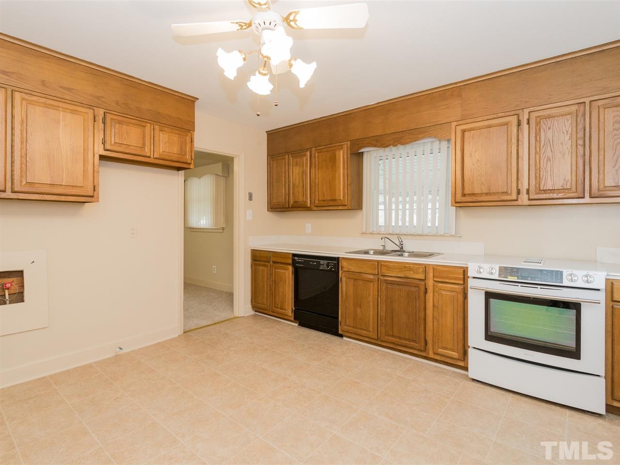 4321 James Road Raleigh, NC 27616 - Photo 8 of 23 a kitchen with stainless steel appliances granite countertop a stove sink and cabinets