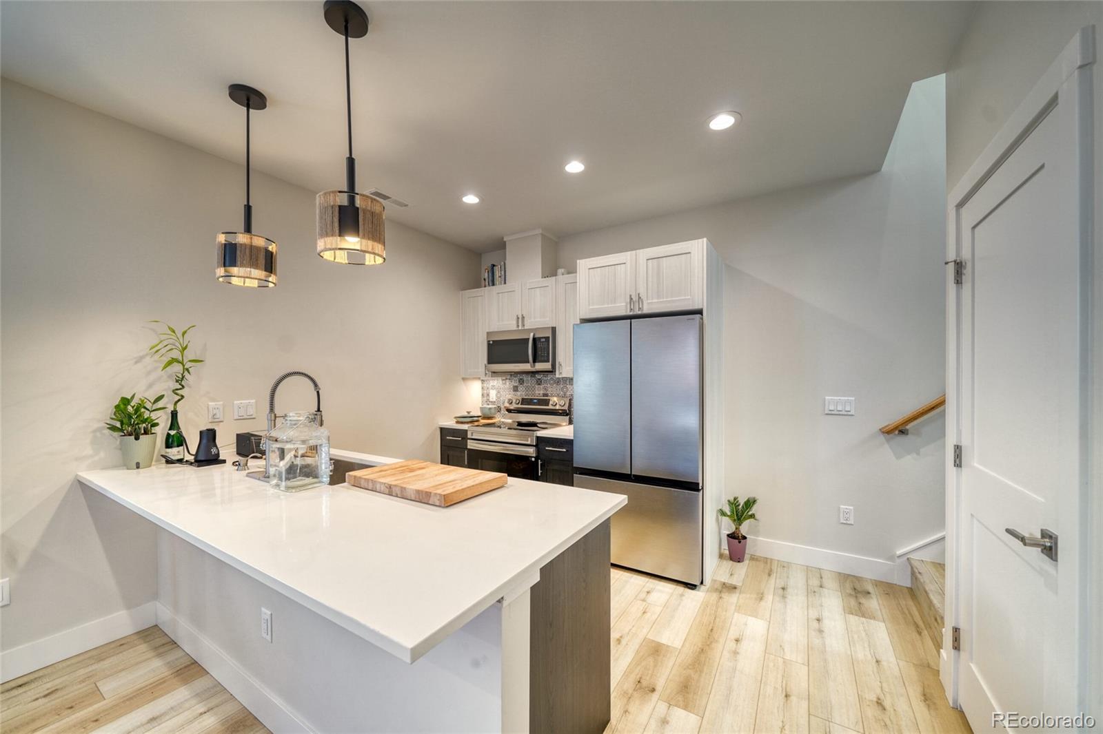 601 Scott Street, Unit A Salida, CO 81201 - Photo 14 of 31 a kitchen with stainless steel appliances kitchen island a sink a refrigerator and a cabinets