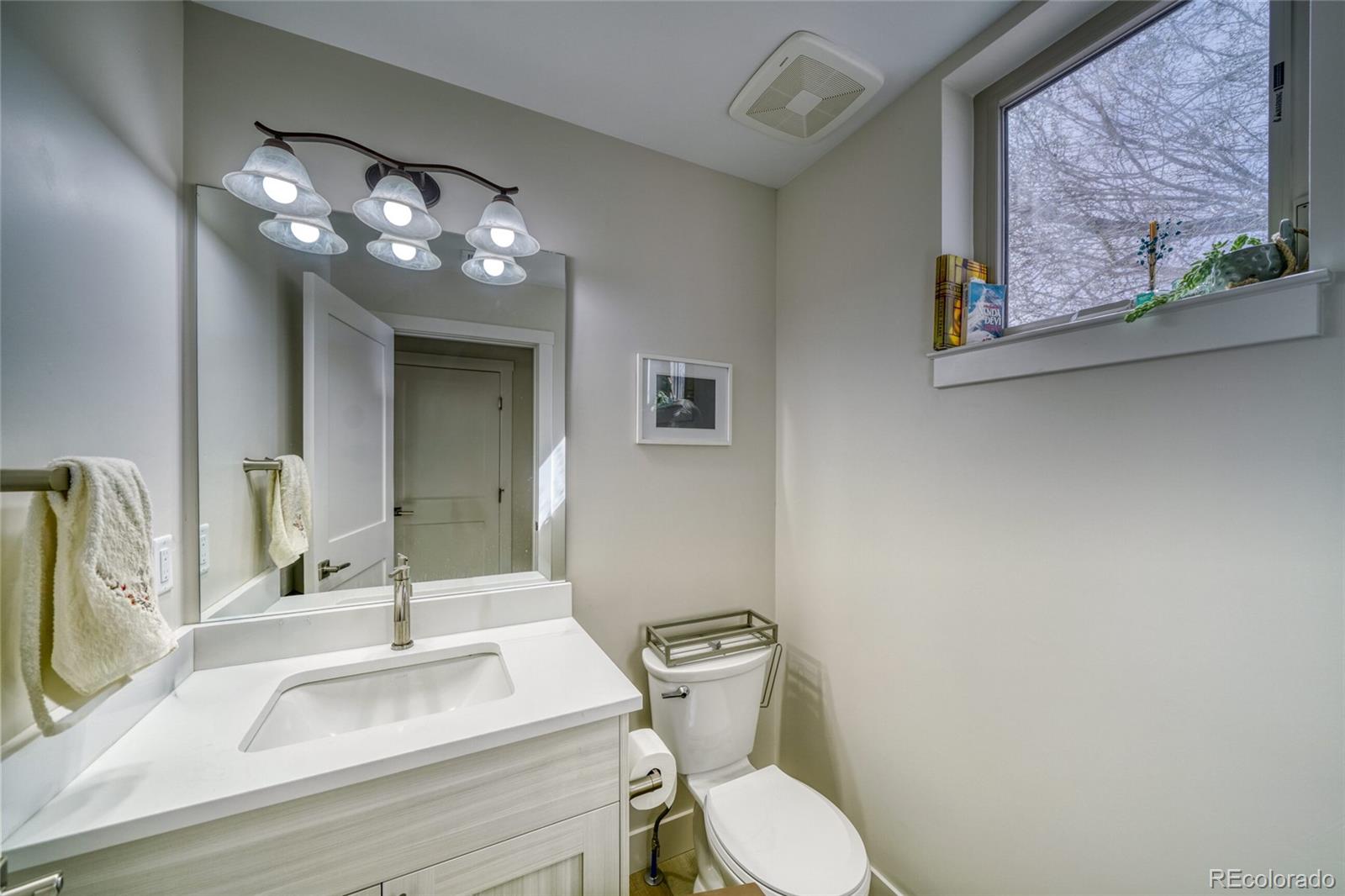 601 Scott Street, Unit A Salida, CO 81201 - Photo 18 of 31 a bathroom with a toilet sink and mirror