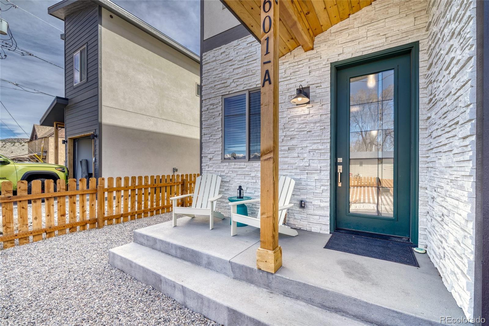 601 Scott Street, Unit A Salida, CO 81201 - Photo 8 of 31 a view of a brick house with a chairs and table in a patio
