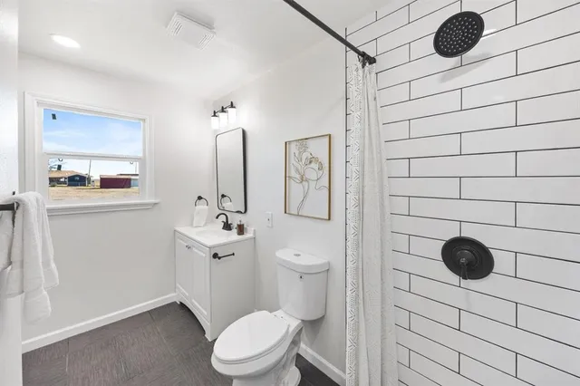 a bathroom with a toilet sink shower