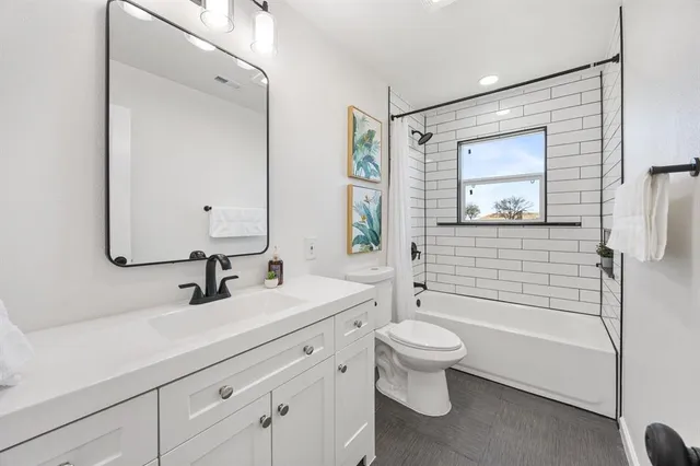 a bathroom with a double vanity sink toilet mirror and shower