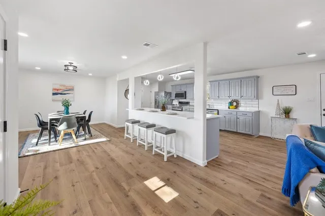 a living room with furniture and view of kitchen