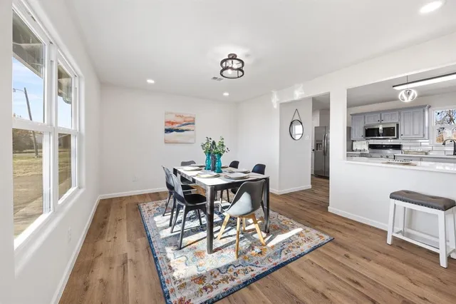 a view of a dining room with furniture window and wooden floor