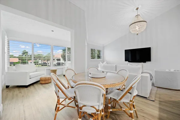 a view of a dining room with furniture wooden floor and chandelier