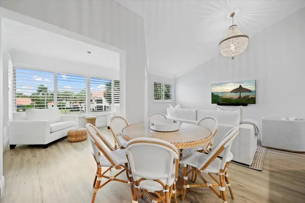 a view of a dining room with furniture wooden floor and chandelier