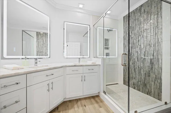 a bathroom with a shower sink and mirror