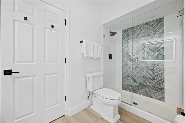 a bathroom with a toilet and shower