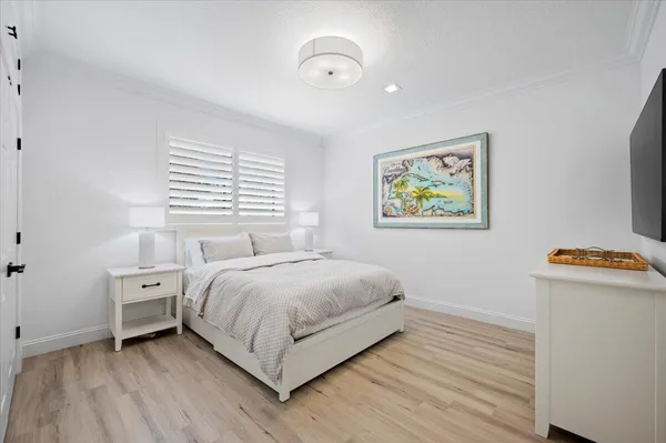 a view of bedroom with natural light and wooden floor