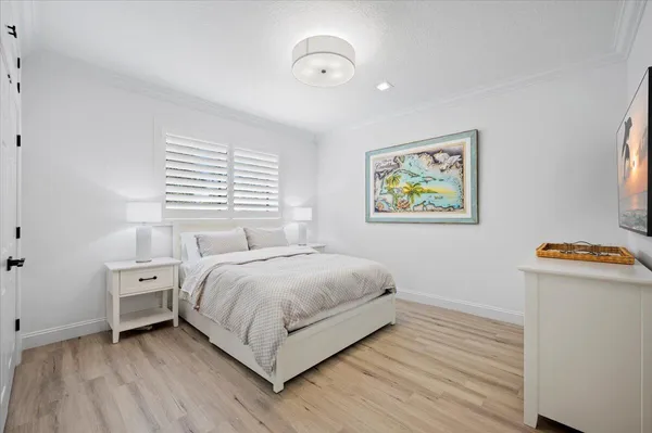 a view of bedroom with natural light and wooden floor