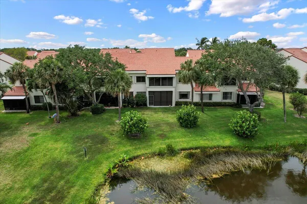 a view of a house with a backyard and a patio