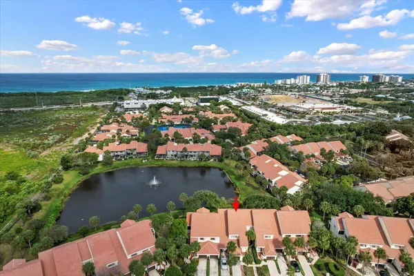 an aerial view of residential building and lake