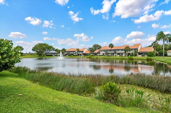 a view of a lake with houses in the back