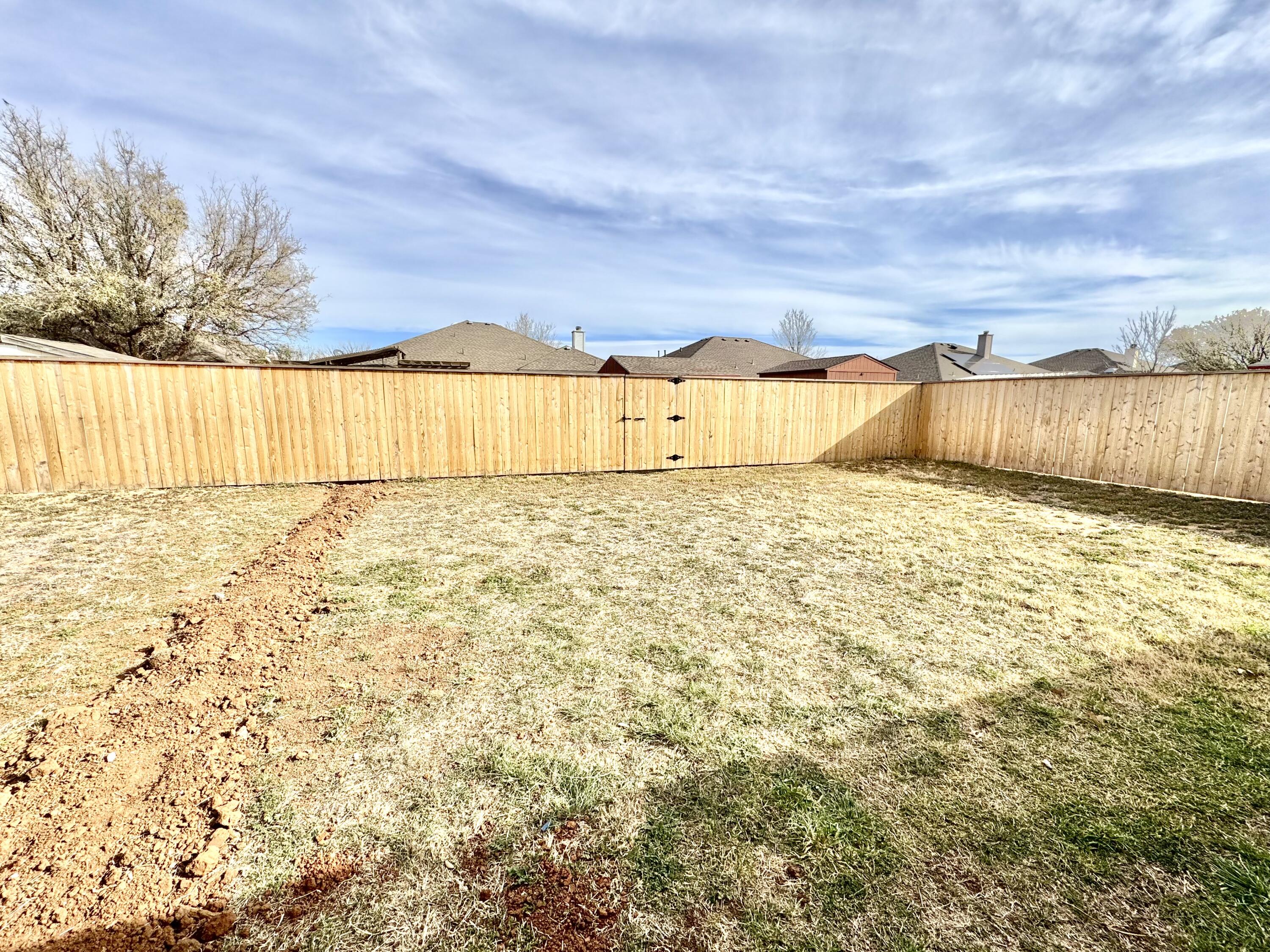 6536 7th Street Lubbock, TX 79416 - Photo 20 of 20 a view of a yard with an trees