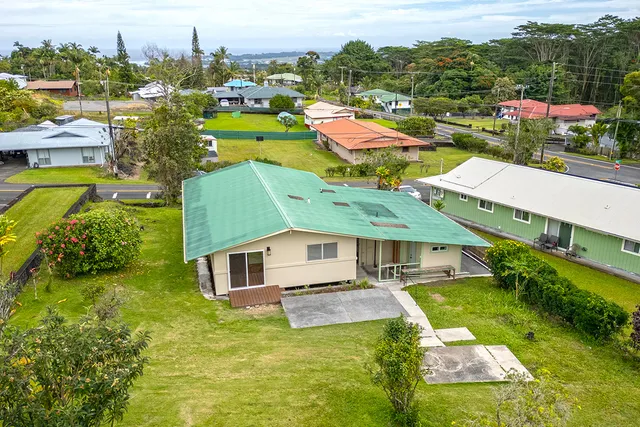 an aerial view of residential houses with outdoor space and swimming pool