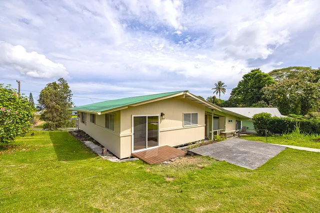 a front view of a house with a yard garage and outdoor seating